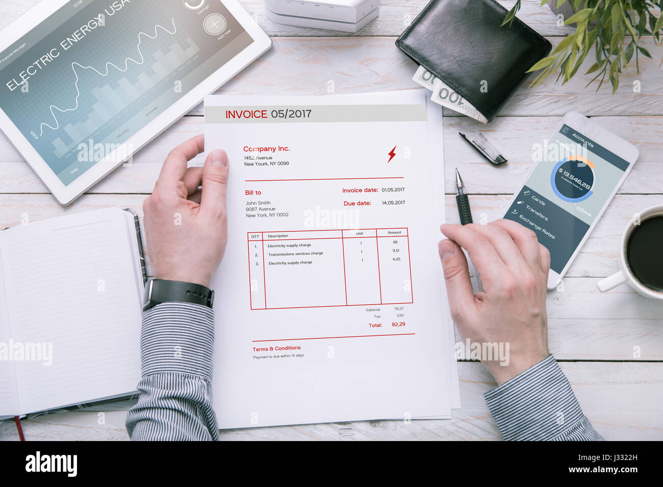 Chi detiene la fattura di energia elettrica dell'utilizzo oltre scrivania con tablet e smartphone con le domande presentate nel programma di grafica. Foto Stock