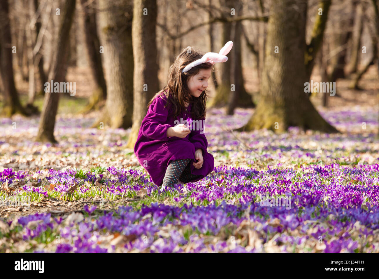 Bambina con banny orecchie nella primavera del parco Foto Stock