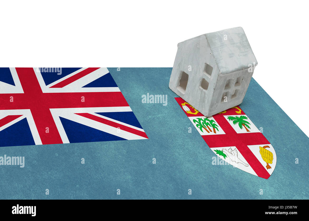 Piccola casa su una bandiera - vivere o la migrazione verso le isole Figi Foto Stock