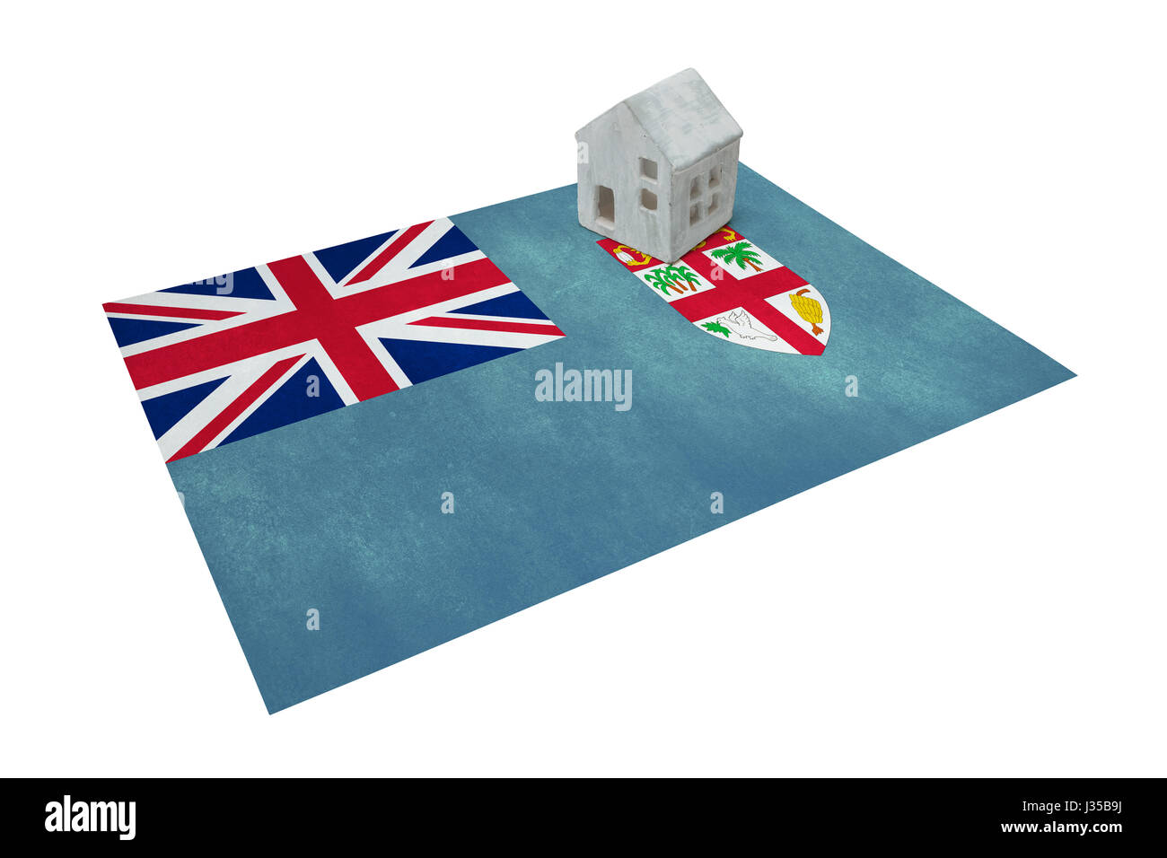 Piccola casa su una bandiera - vivere o la migrazione verso le isole Figi Foto Stock