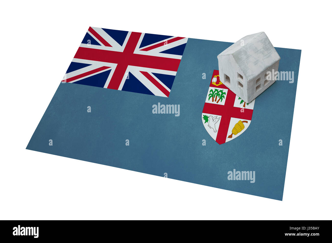 Piccola casa su una bandiera - vivere o la migrazione verso le isole Figi Foto Stock