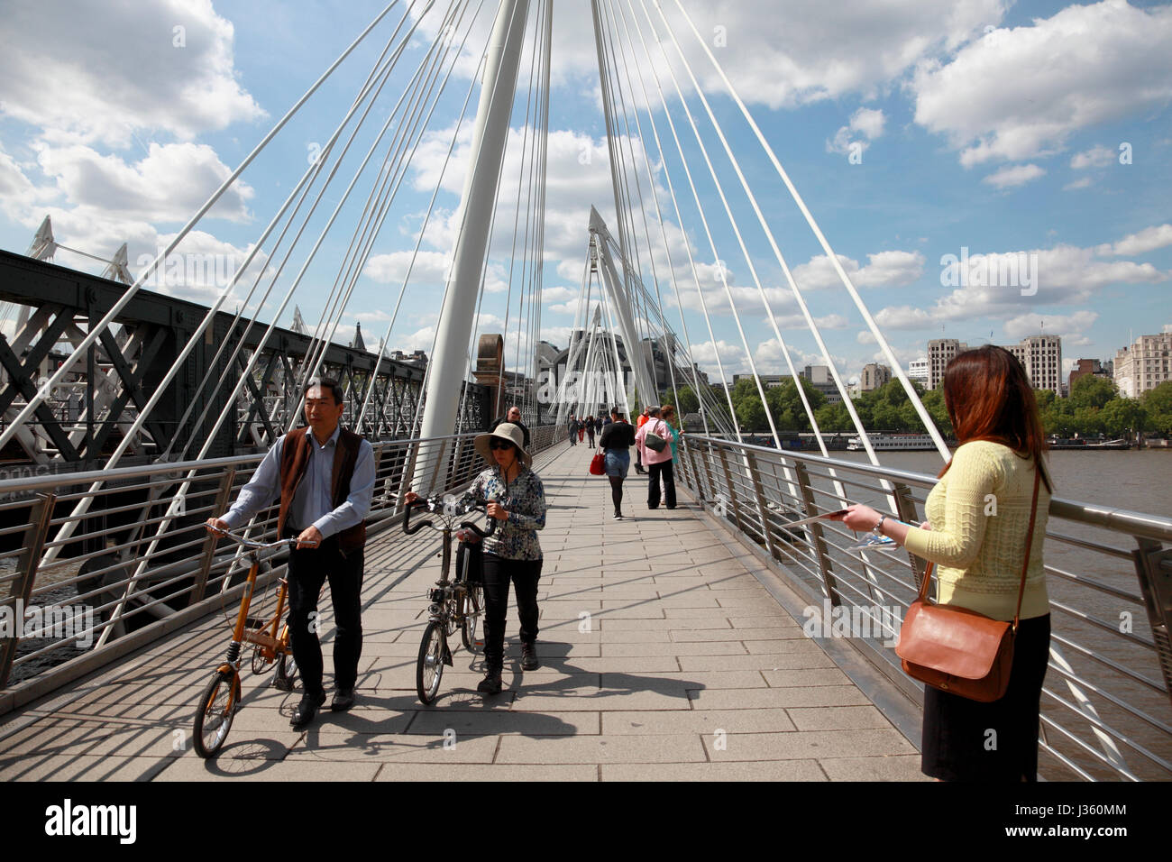 Turisti attraversando uno dei Golden Jubilee ponti accanto al London Southbank Foto Stock