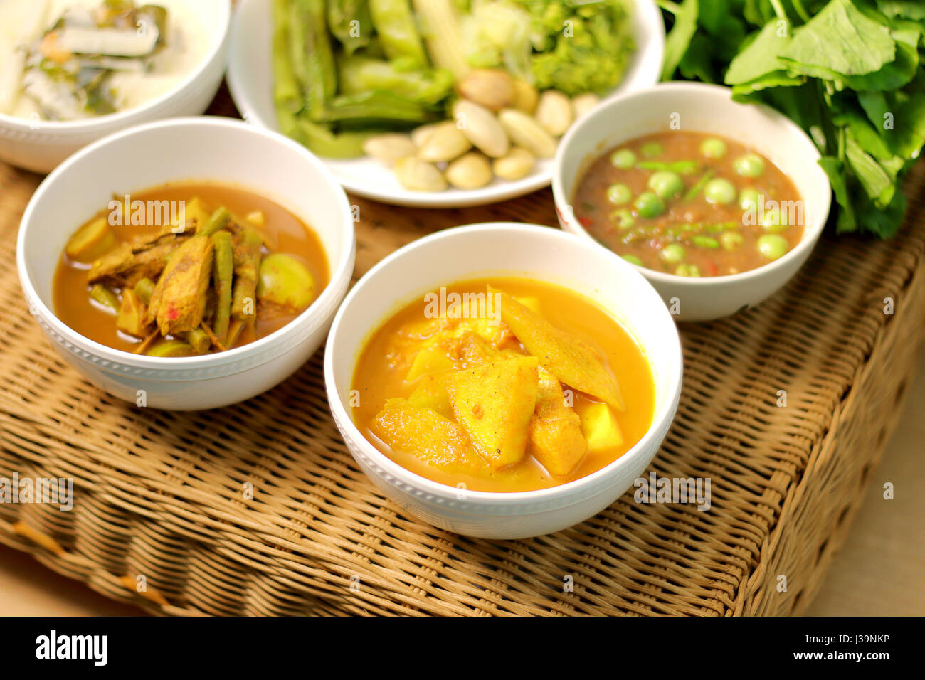 Sour zuppa di pesce e a resca di pesce, organi sour zuppa, pasta di peperoncino piccante, cibo tailandese menu sul tavolo rattan Foto Stock