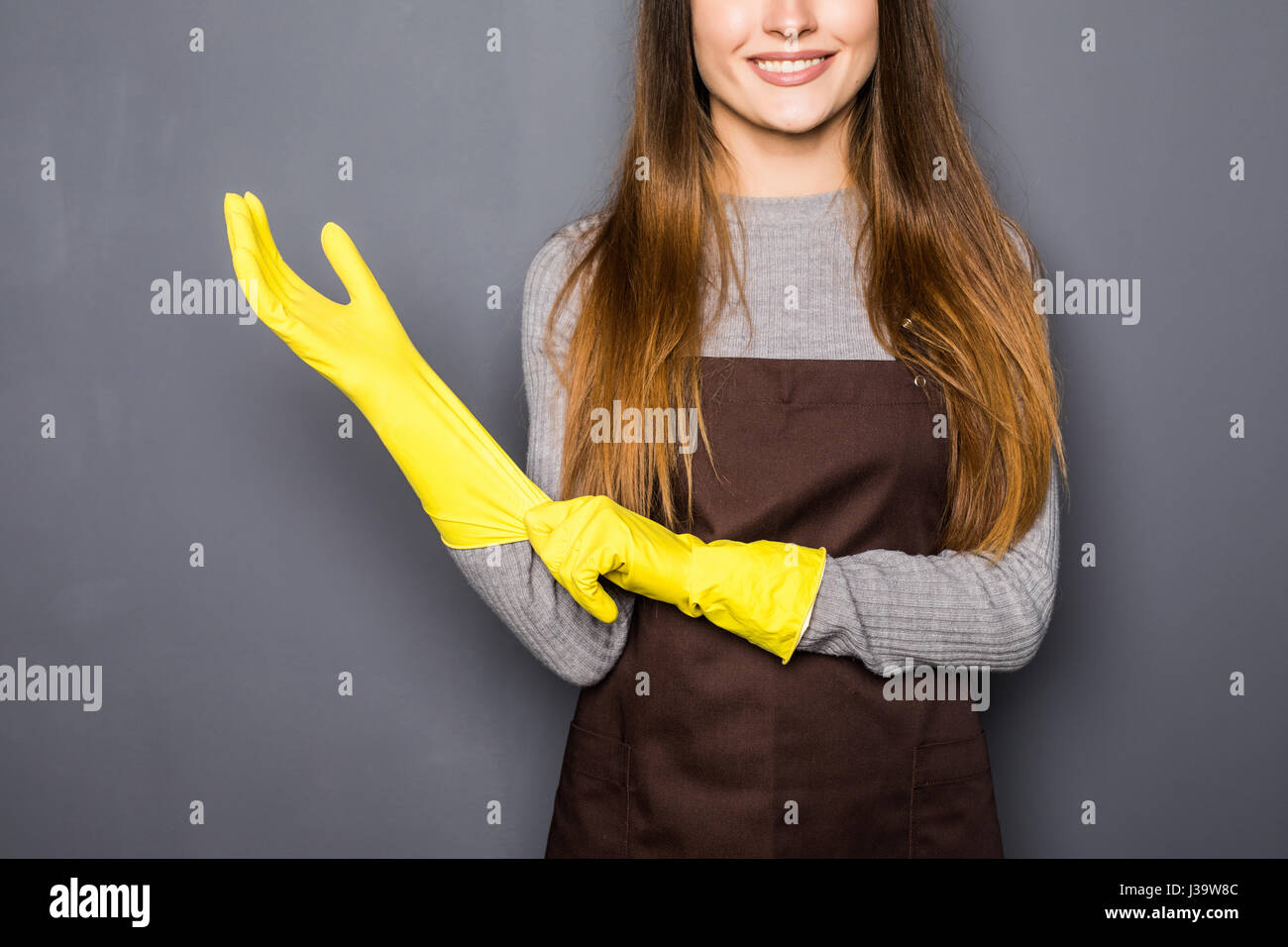 Giovane donna di colore giallo che indossa guanti di gomma isolato su  grigio Foto stock - Alamy