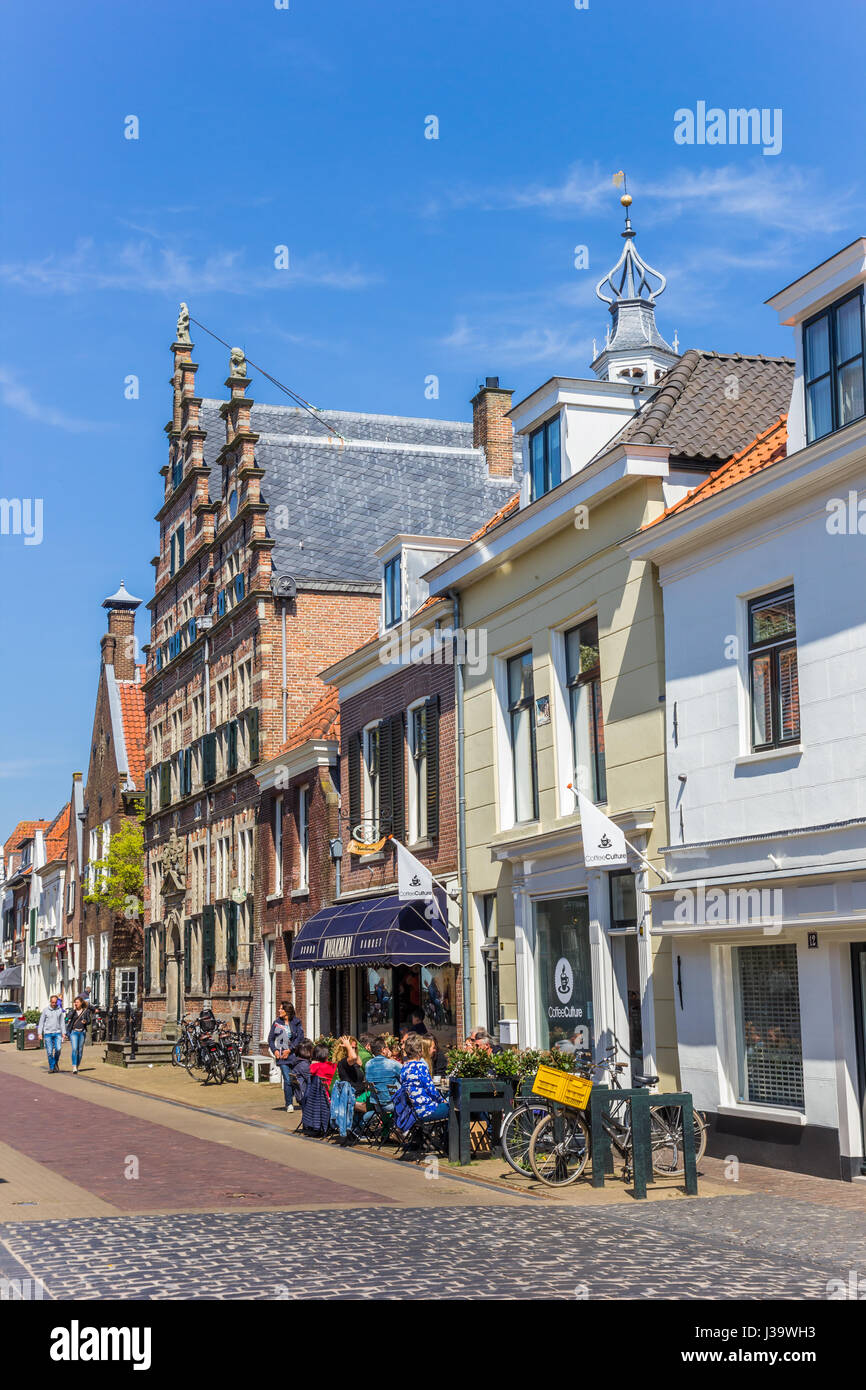 La gente seduta al sole nella strada principale di Naarden, Paesi Bassi Foto Stock