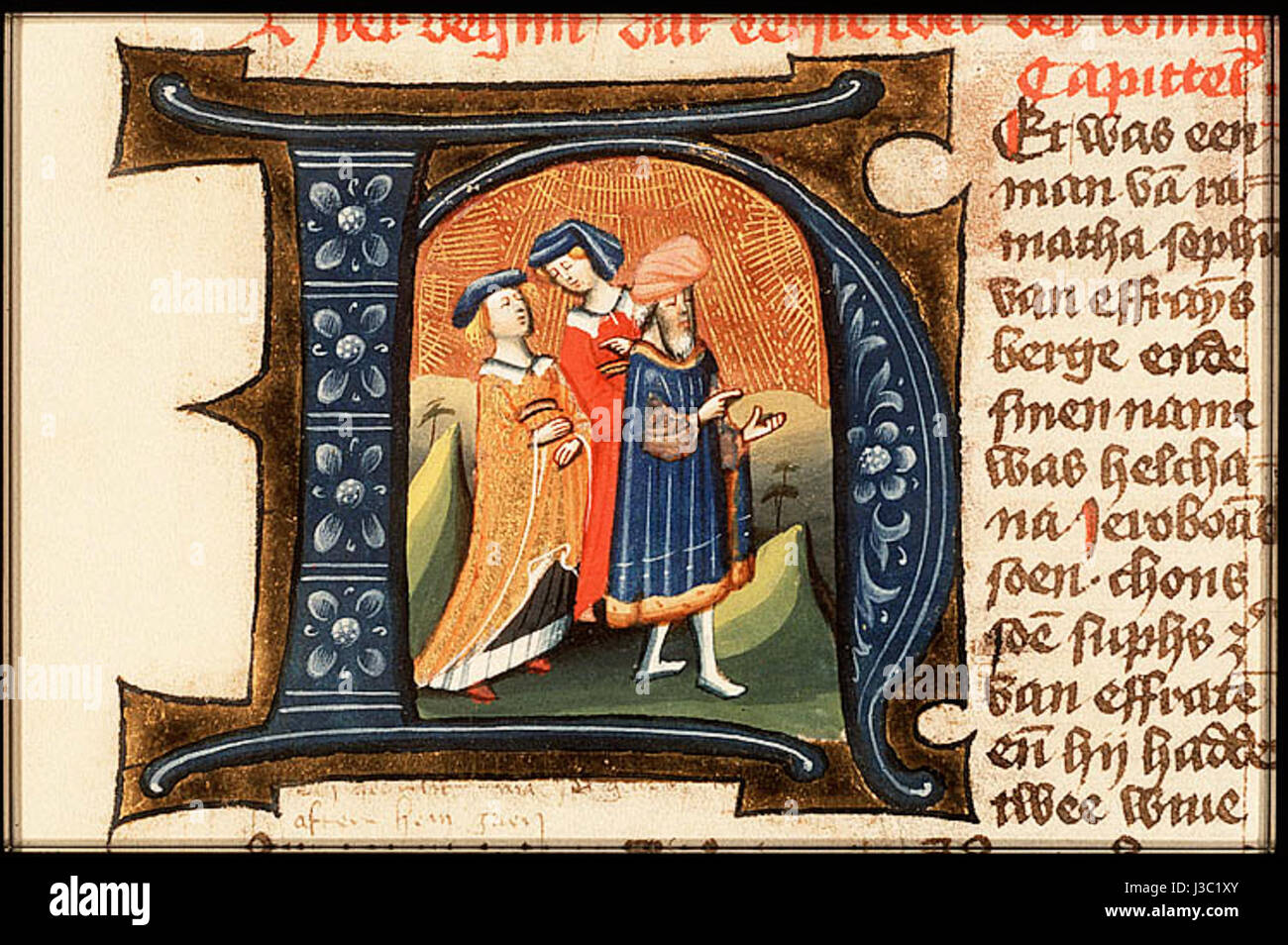 Questa lettera illuminata mostra una scena biblica con Elkanah e le sue mogli, splendidamente decorata con disegni intricati. L'opera fa parte di un manoscritto religioso, che mette in risalto lo stile artistico e i temi religiosi del periodo. Foto Stock