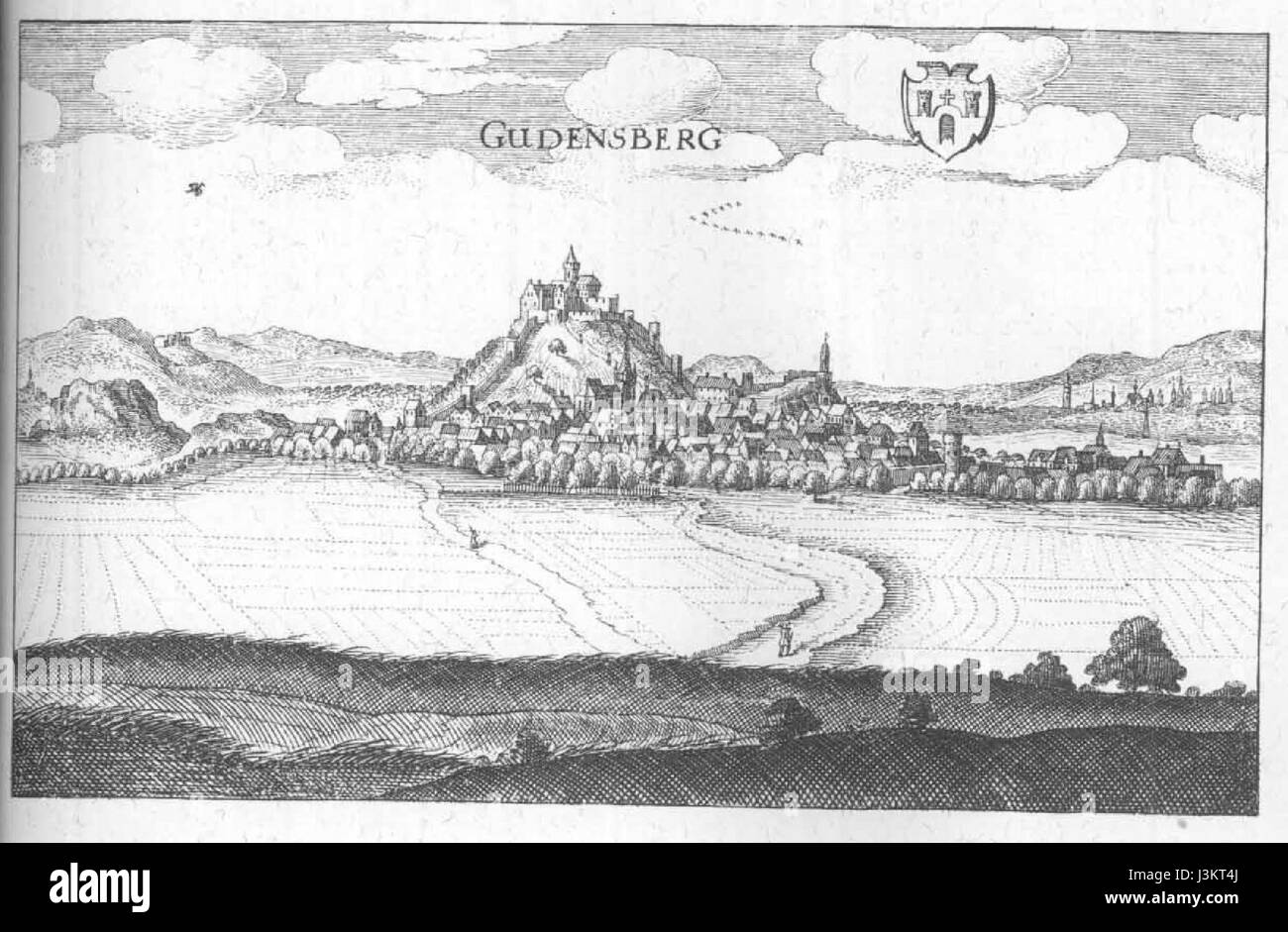 Gudensberg è una città in Germania, e questo titolo si riferisce probabilmente a una mappa storica o incisione di Merian, un artista svizzero noto per le sue opere topografiche. L'immagine probabilmente raffigura il layout o le caratteristiche architettoniche di Gudensberg. Foto Stock