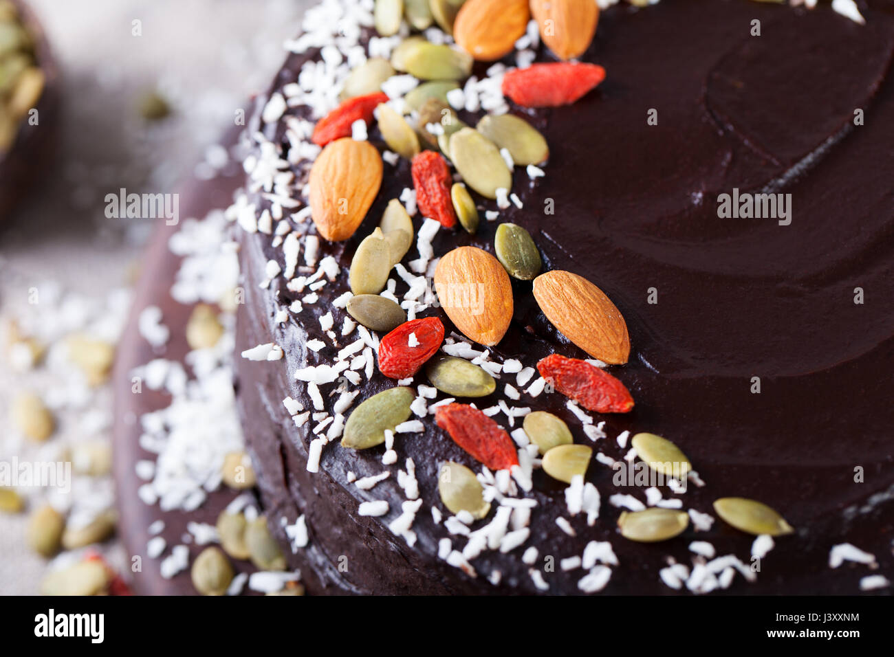 Vegano barbabietole al cioccolato torta con glassa di avocado, decorate con noci e semi. Vista dall'alto. Copia dello spazio. Foto Stock