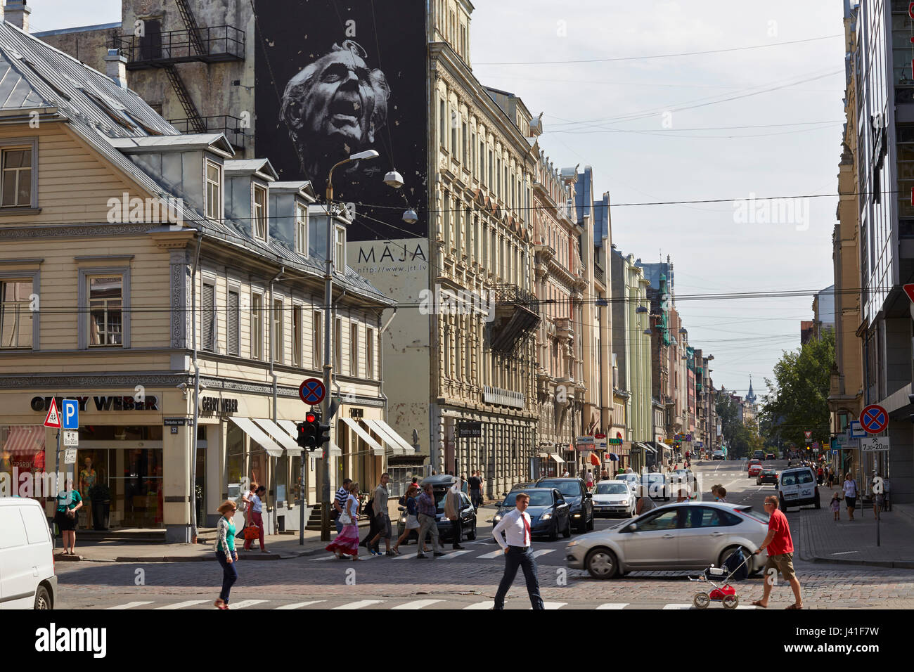 Attraversamento pedonale Lacplesa Iela e Terbatas Iela, murale di un teatro, hip area dello shopping, centro di Riga, Lettonia Foto Stock