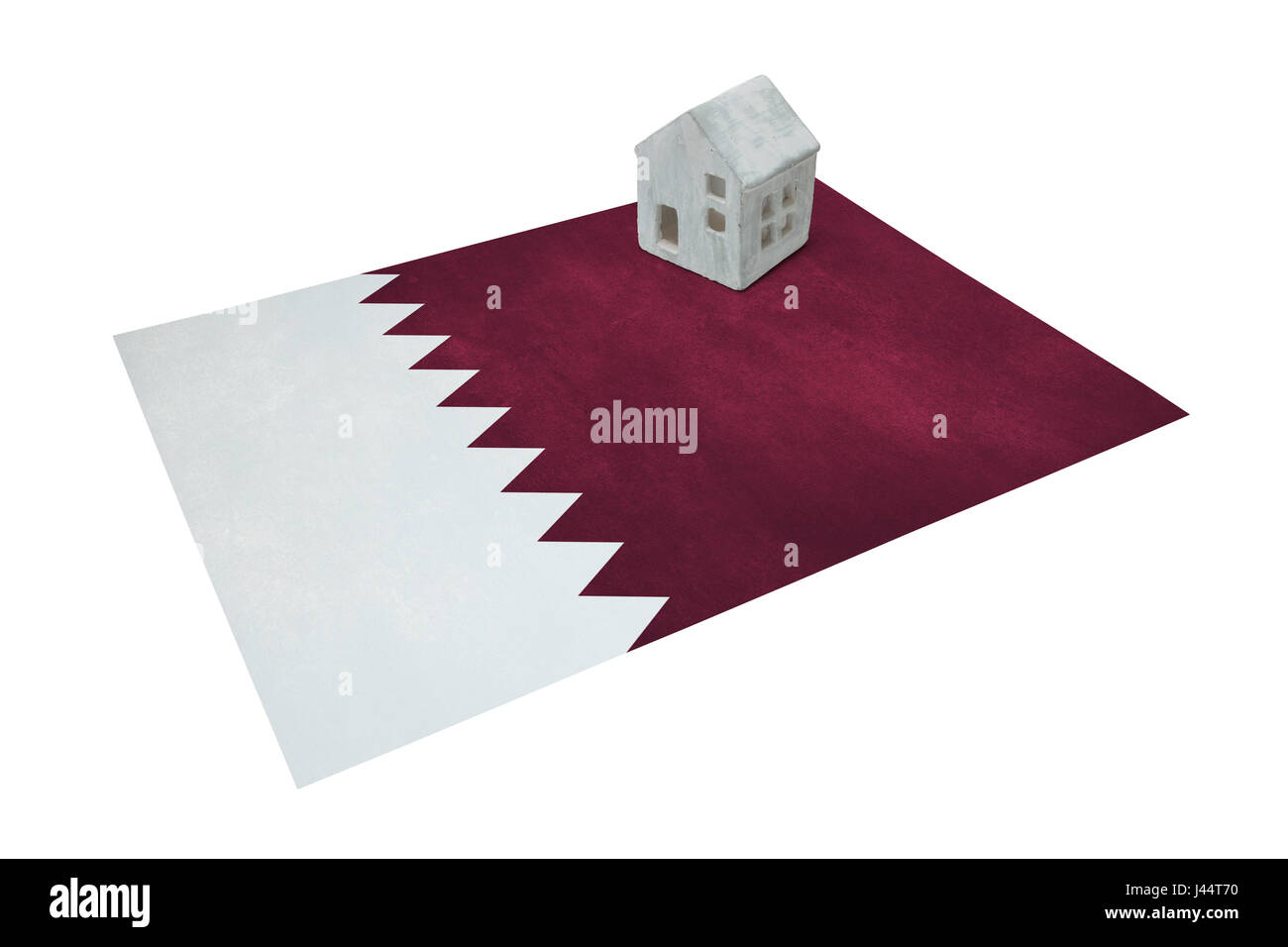 Piccola casa su una bandiera - vivere o la migrazione di Qatar Foto Stock