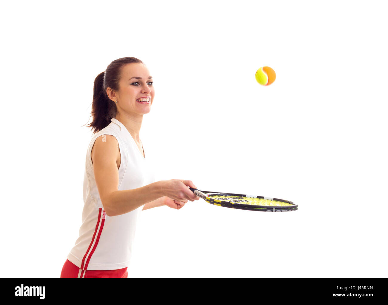 Donna che gioca con la racchetta da tennis Foto Stock