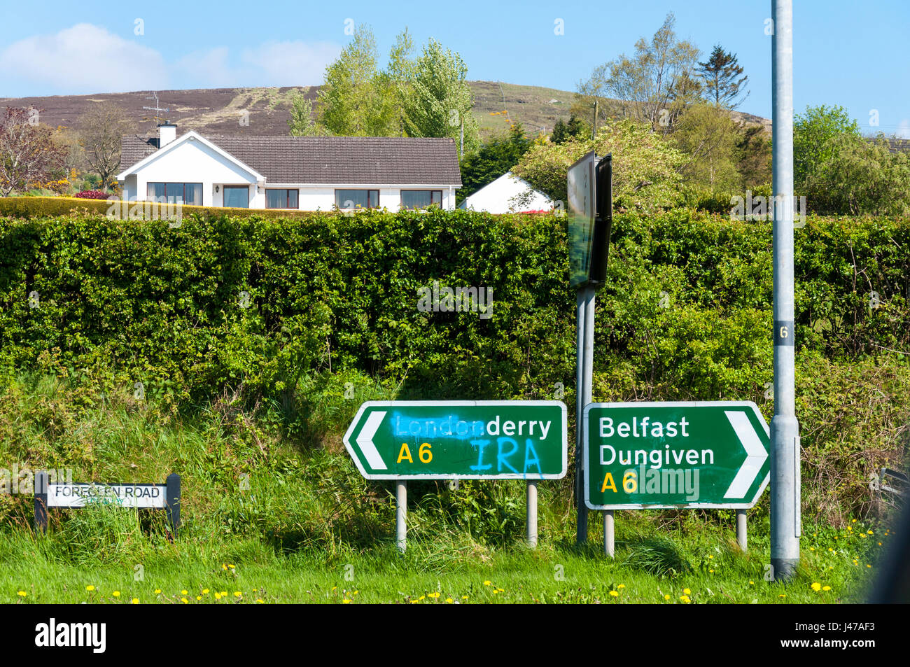 Rovinato cartello stradale vicino Claudy nella Contea di Londonderry, Irlanda del Nord Regno Unito. Foto Stock