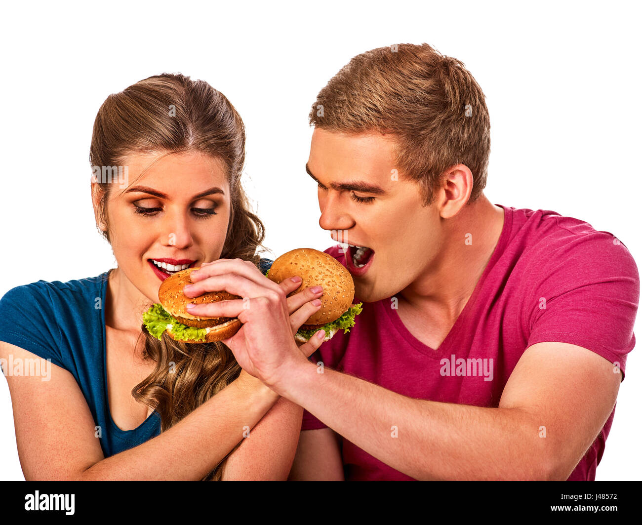 Paio di mangiare fast food. L uomo e la donna a mangiare hamburger. Foto Stock