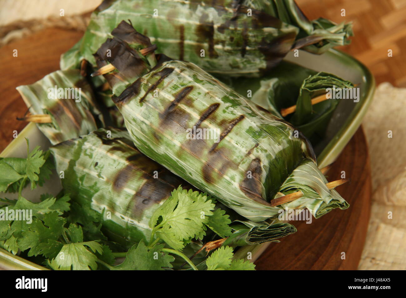 Lalampa, grigliate torta di riso con sgombro affumicato da Manado Foto Stock