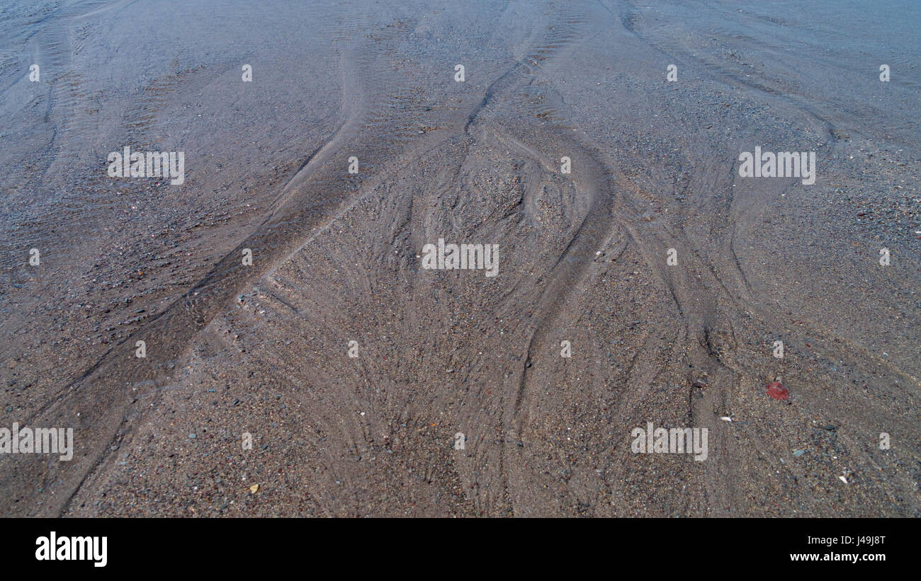 Spiaggia di sabbia texture in sole primaverile Foto Stock