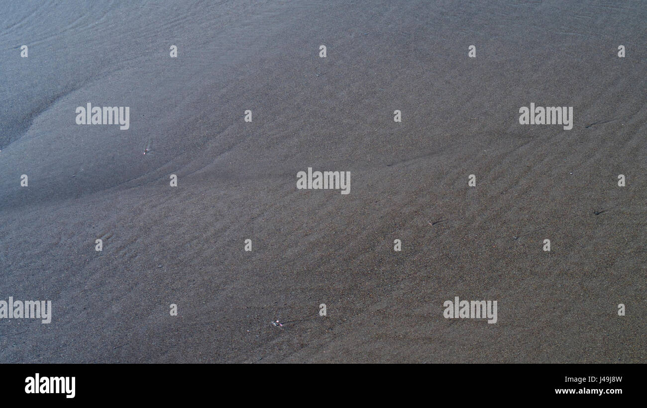 Spiaggia di sabbia texture in sole primaverile Foto Stock