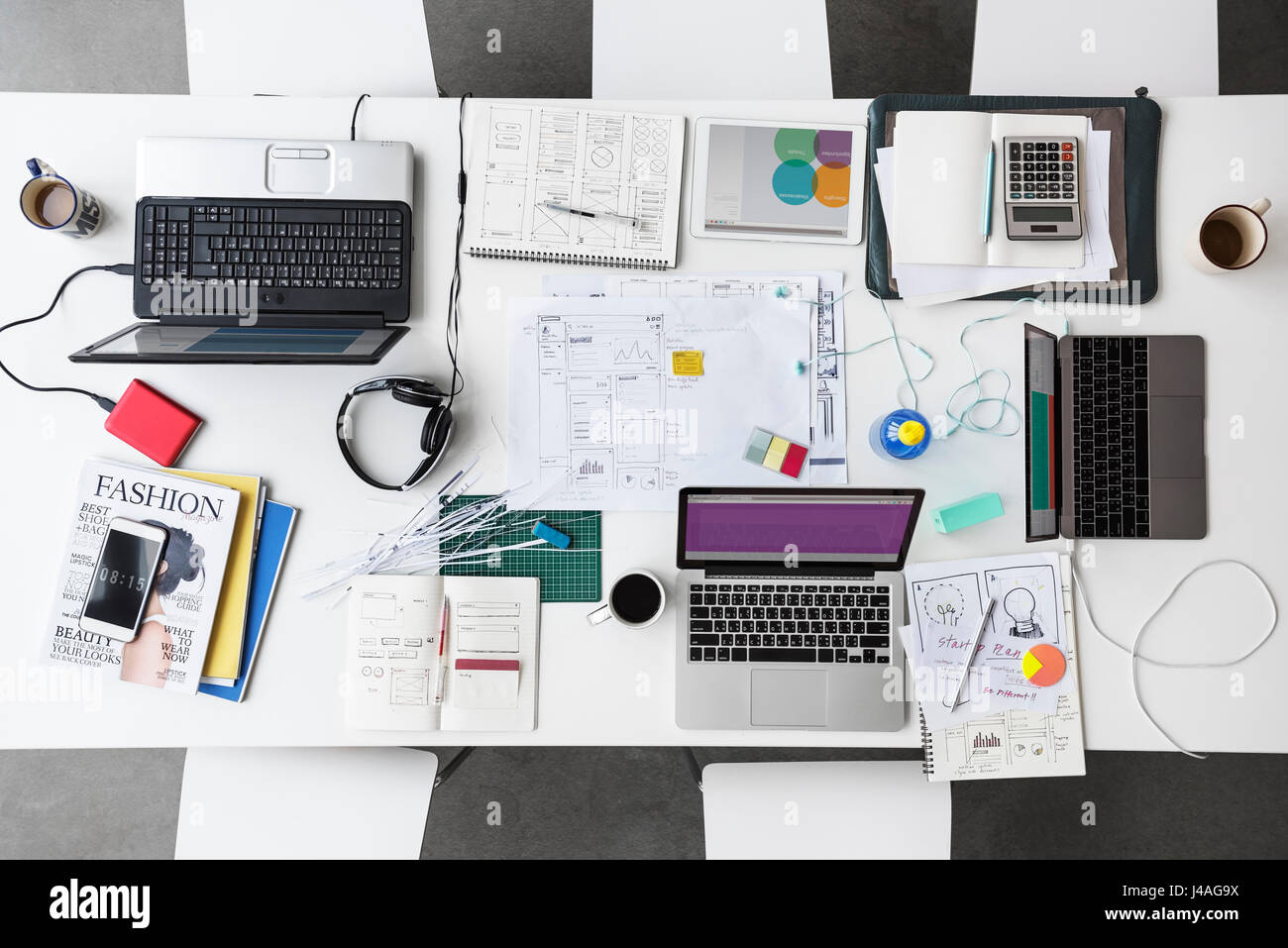 Di lavoro tavolo bianco con laptop e notebook di design creativo di persone Foto Stock