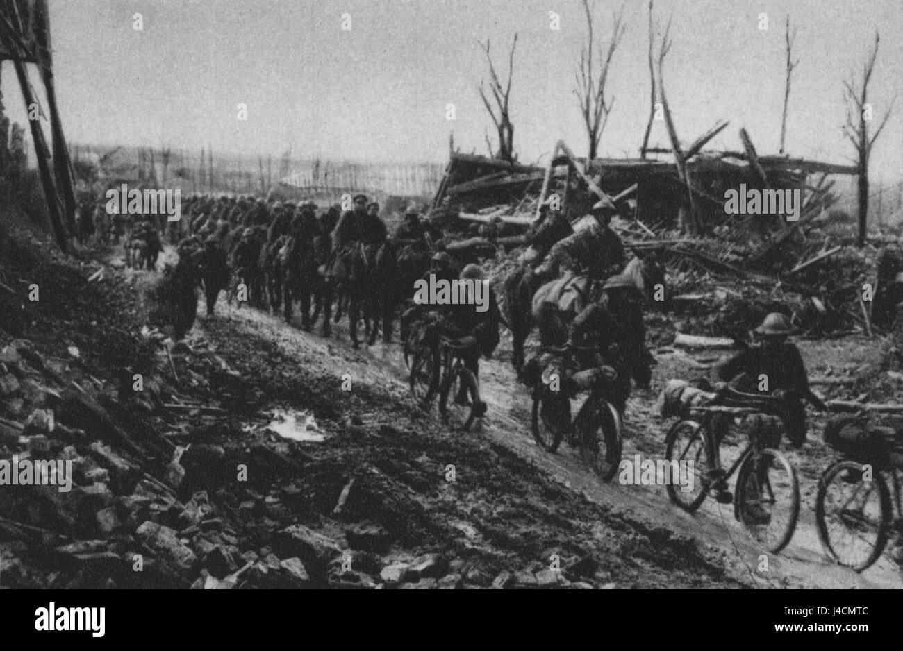 Una scena storica della prima guerra mondiale, che mostra una compagnia di ciclisti e una brigata di cavalleria britannica che marciano lungo una strada vicino a Cambrai, in Francia. La foto cattura i preparativi militari durante la guerra. Foto Stock