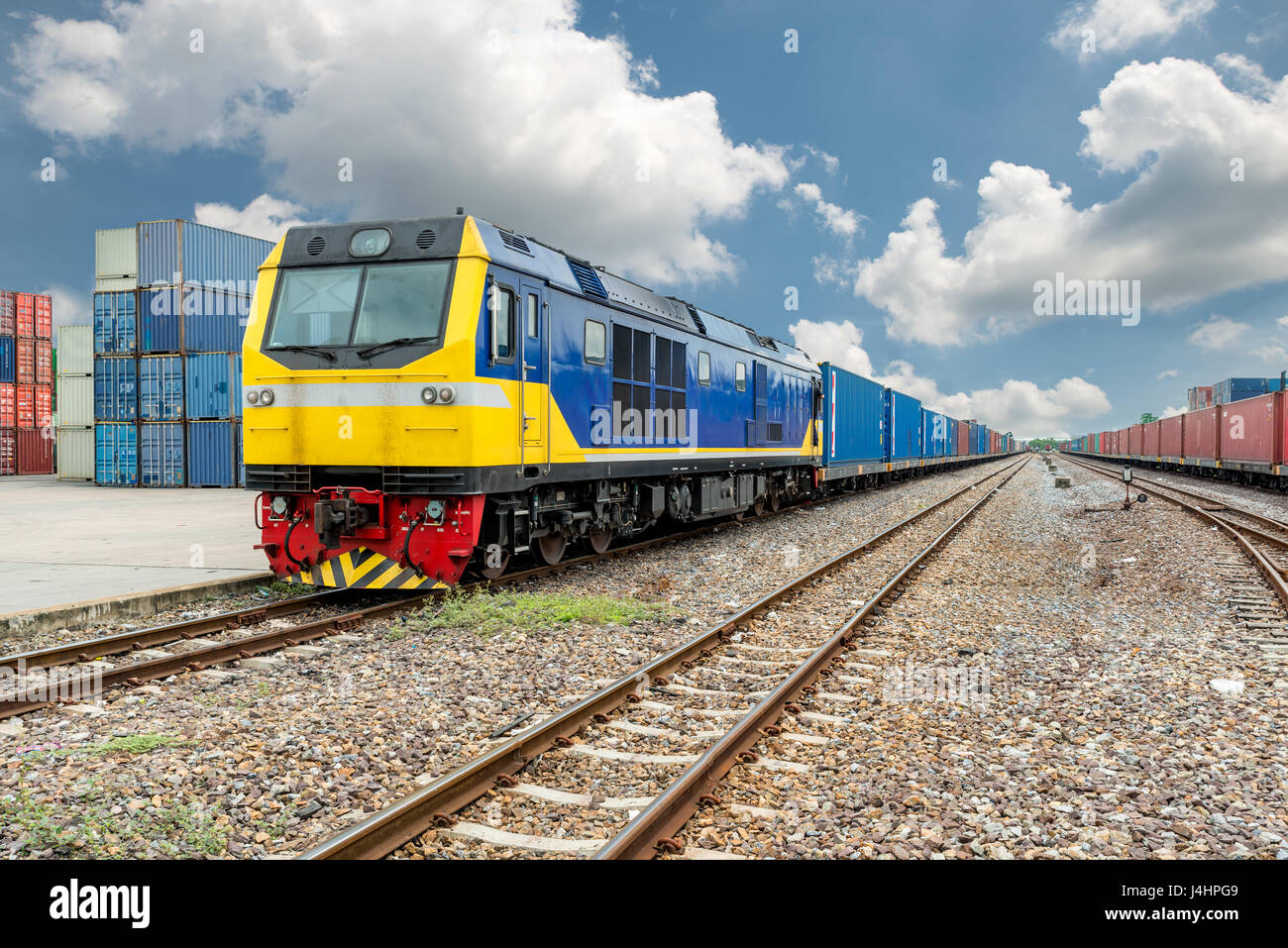 Treno merci piattaforma con treno merci contenitore al magazzino porta in uso per logistica di esportazione dello sfondo. Foto Stock