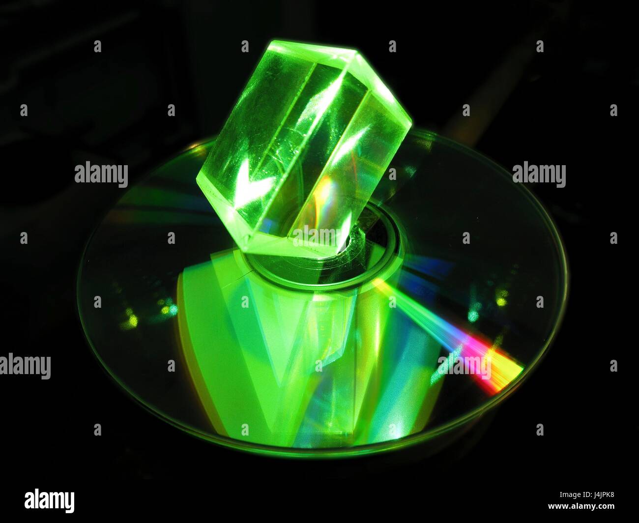 Prisma di vetro e laser. Prisma di vetro illuminato con luce laser verde, con una riflessione visto in un disco ottico. Compact disc (CD) e digital versatile disc (DVD) sono esempi di dischi ottici. Prismi di vetro sono dispositivi ottici utilizzati per rifrangere e di Foto Stock