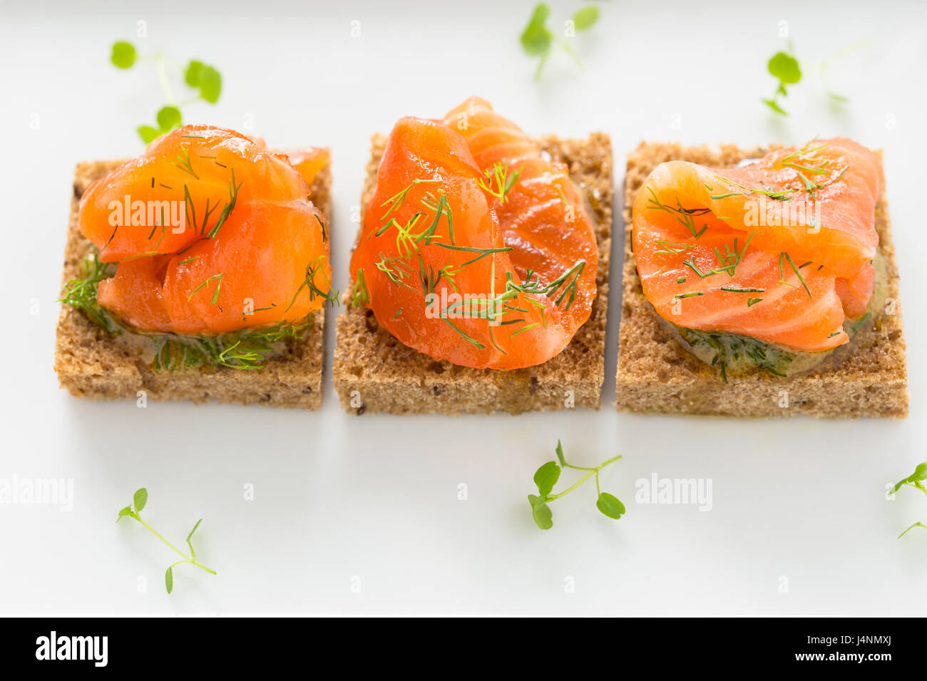 Deliziosi antipasti crostini di pane nero con salmone affumicato per le vacanze Foto Stock