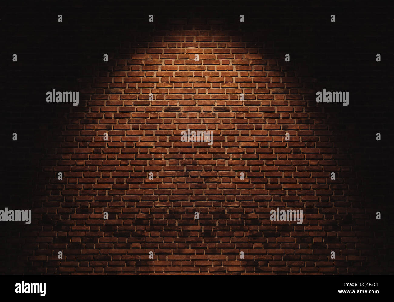 Muro di mattoni texture, con la luce spot Foto Stock