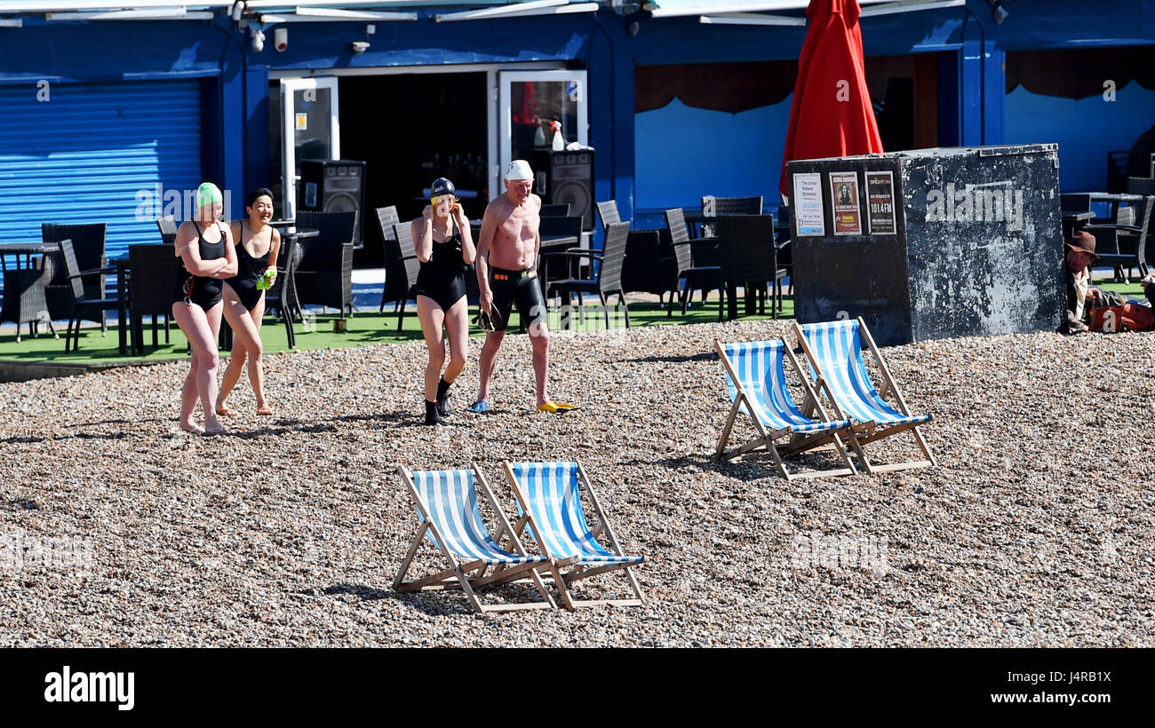 Brighton, Regno Unito. 14 maggio, 2017. mattina presto nuotatori fanno la loro strada verso il mare sulla spiaggia di Brighton in una bella giornata di sole con temperature che dovrebbero raggiungere oltre 20 gradi celsius più tardi nella giornata . credito: simon dack/alamy live news Foto Stock