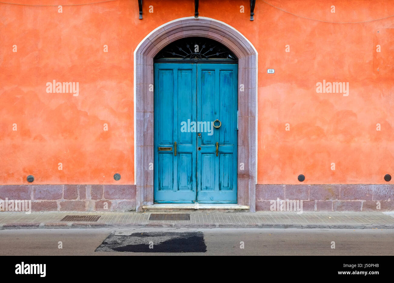 Colorati porta blu e arancione casa dipinta di parete, Bosa, Sardegna, Italia Foto Stock