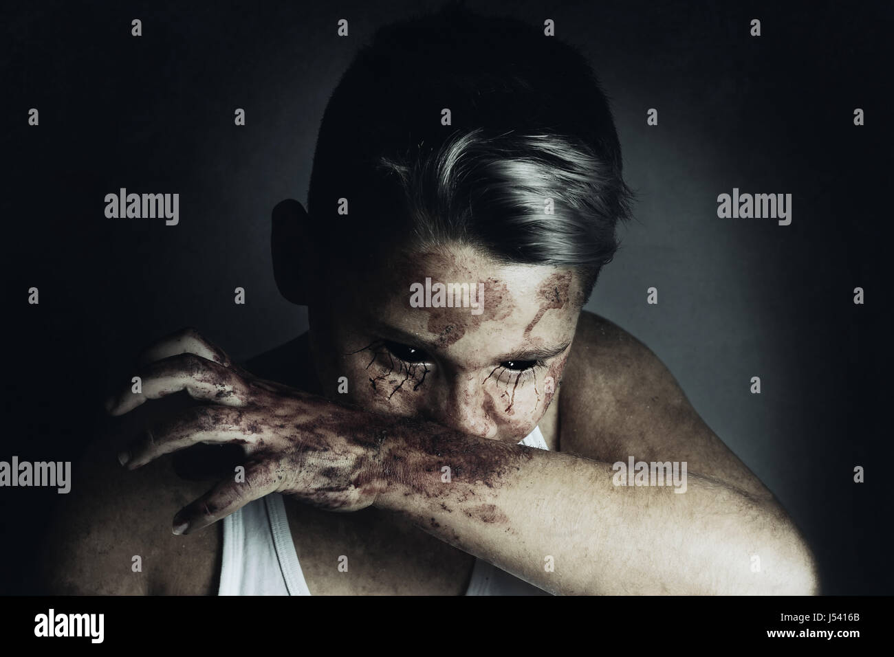 Ritratto di angry bloodsucker che pulire la bocca con la mano sanguinosa Foto Stock