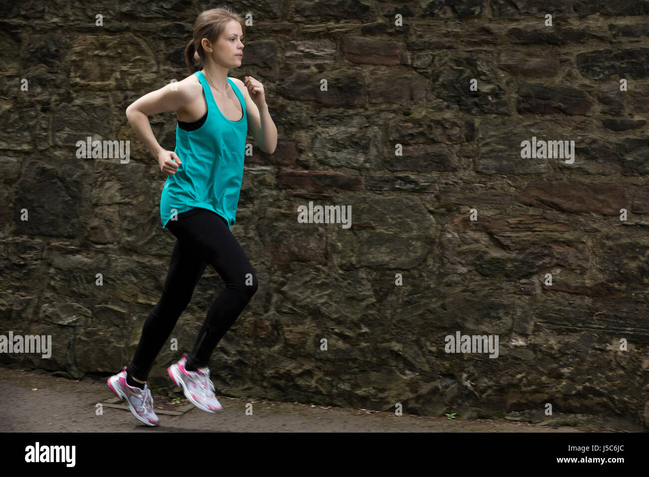 Athletic donna in esecuzione all'esterno. Azione e uno stile di vita sano concetto. Foto Stock