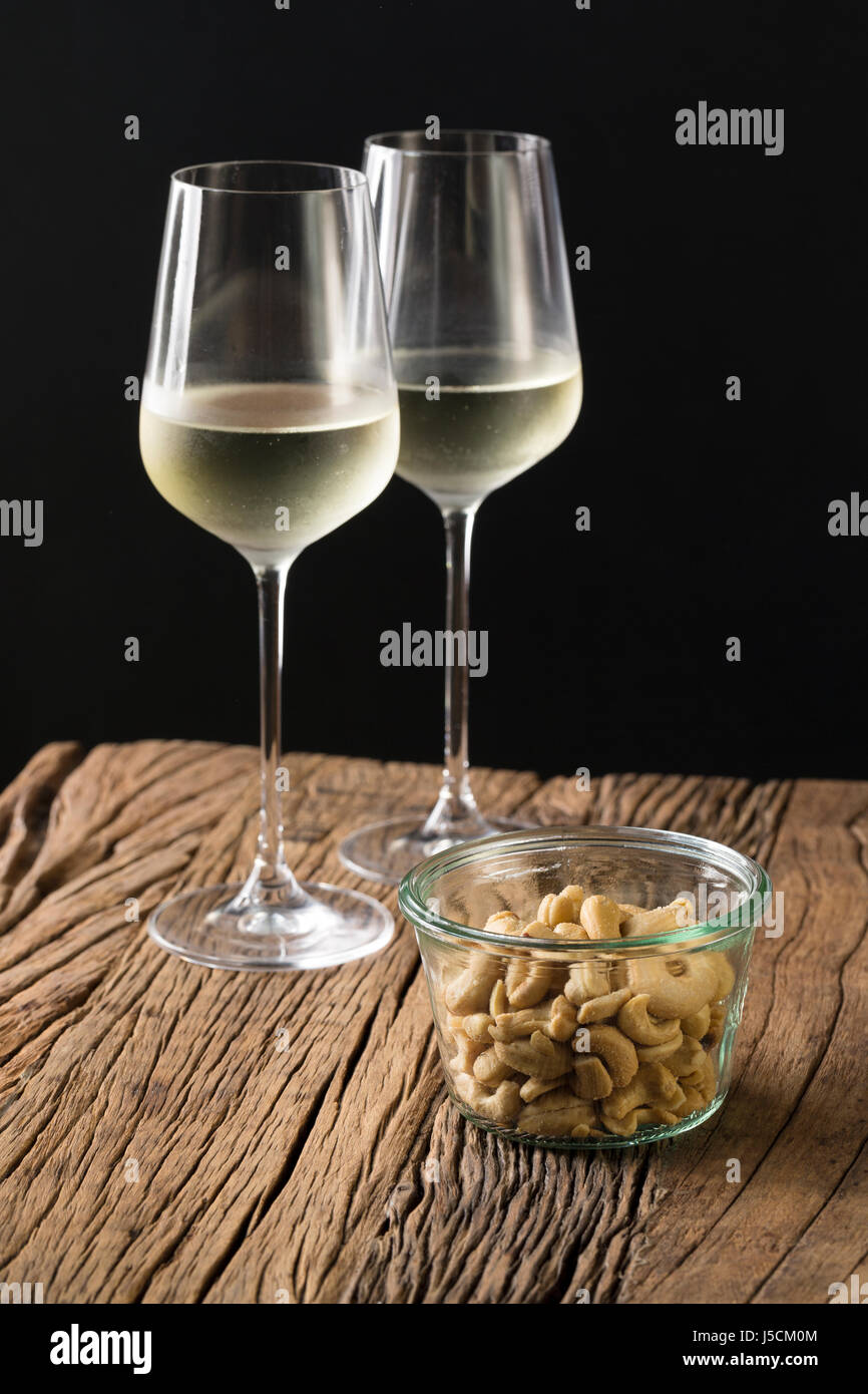 Due bicchieri di vino bianco su una tavola in legno rustico. Foto Stock