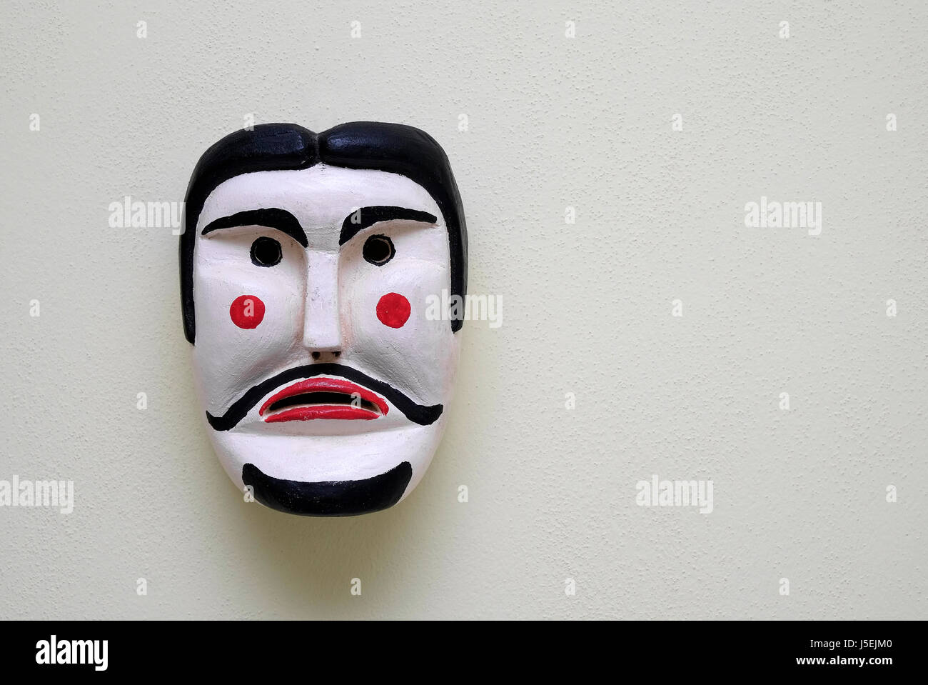 Stile italiano la maschera per il viso fissato alla parete Foto Stock