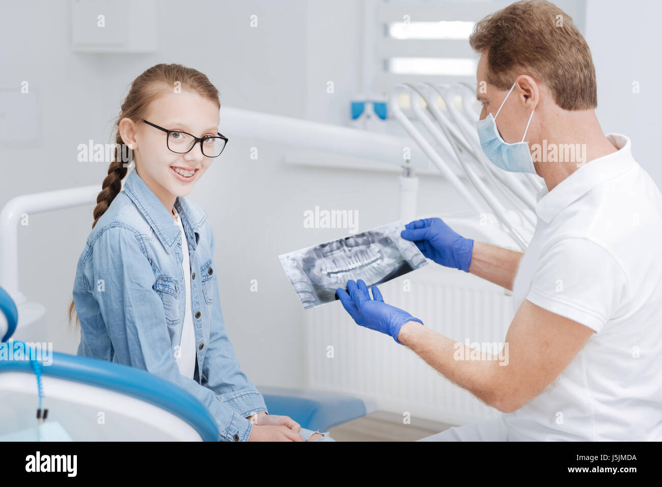 Luminosa ragazza adolescente avente un appuntamento con il suo dentista Foto Stock