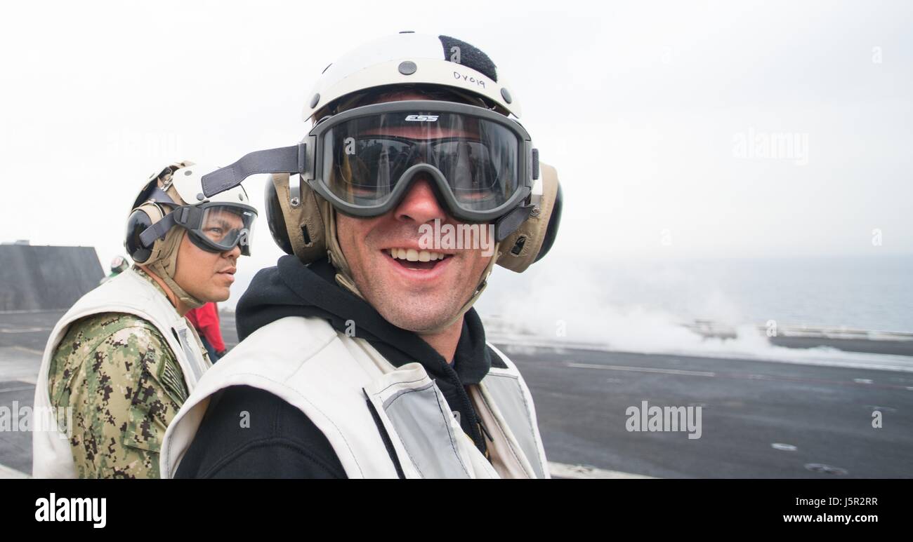 Ultimate Fighting Championship mixed martial artista Dominick Cruz orologi operazioni degli aeromobili per il funzionamento intrinseco risolvere sul ponte di volo a bordo della USN Nimitz-class portaerei USS George H.W. Bush durante un uso tour 29 marzo 2017 nel Golfo Arabico. (Foto di James K. McCann/DoD via Planetpix) Foto Stock