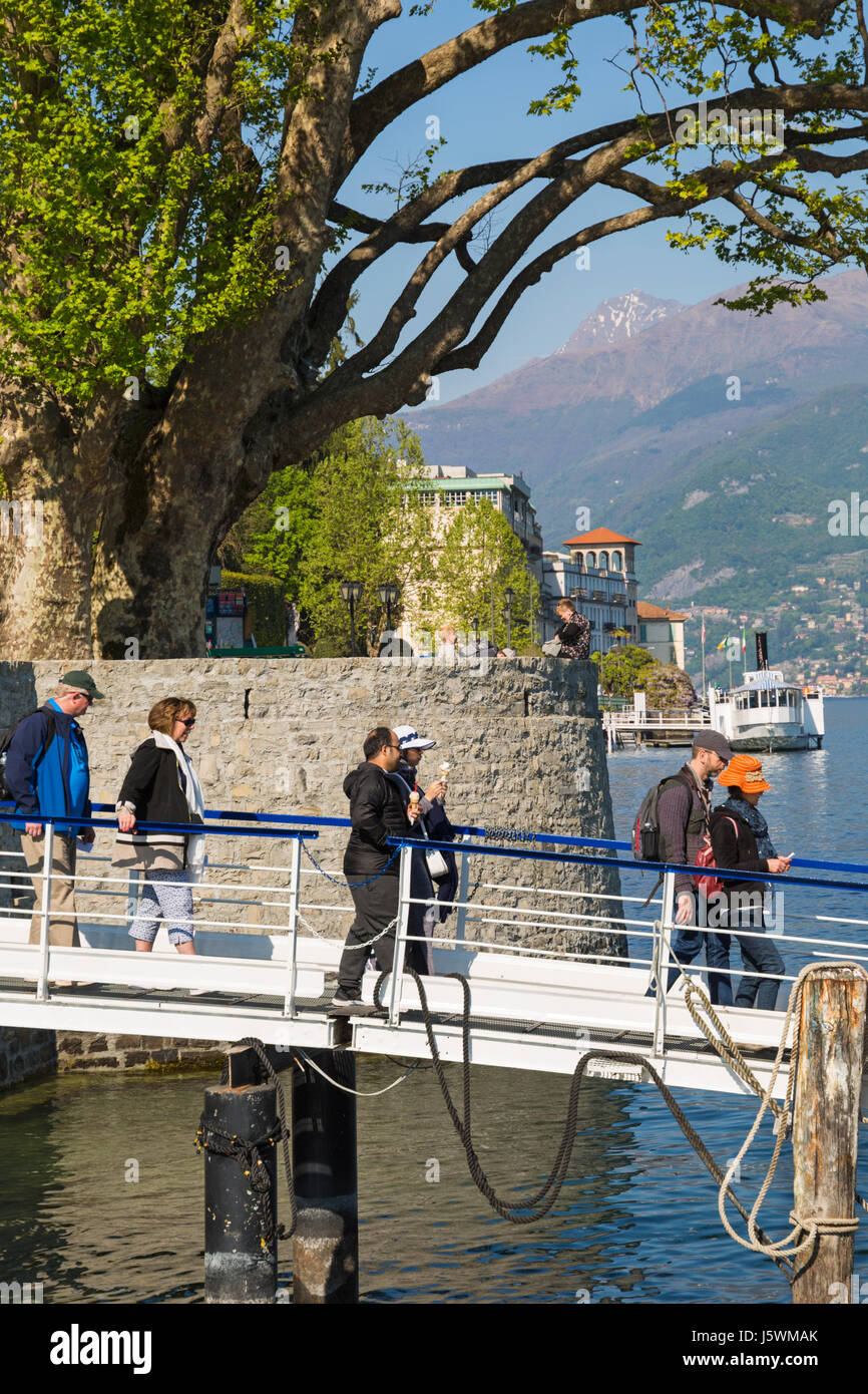 I passeggeri ottenere pronto a salire a bordo del traghetto a Villa Carlotta a Tremezzo Bellagio con battello a vapore in background, Lago di Como, Italia nel mese di aprile Foto Stock