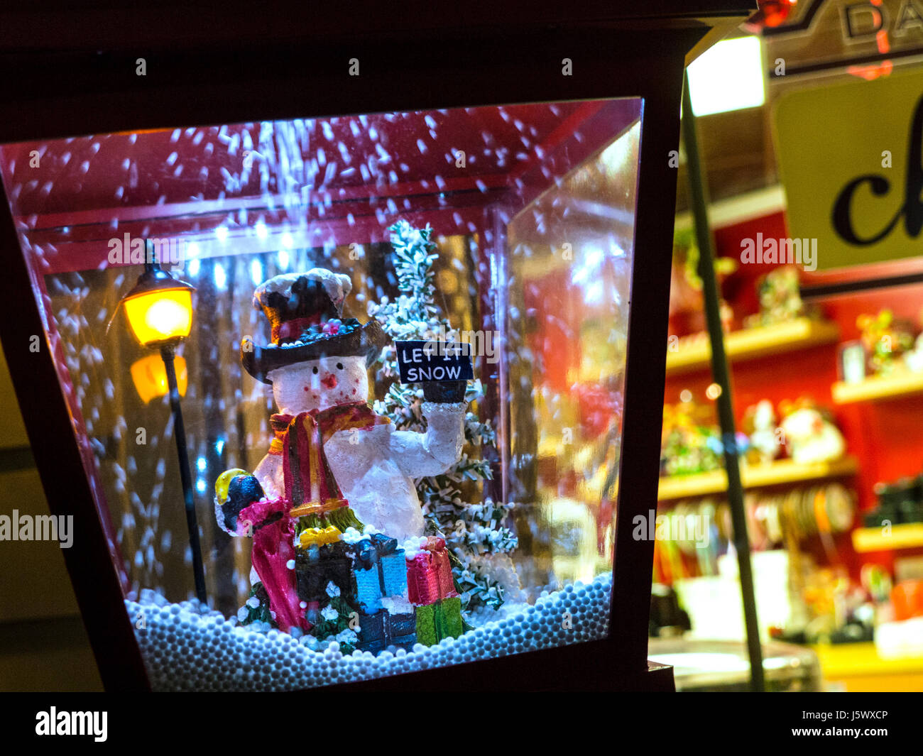 Novità natalizia lampada con pupazzo di neve e fiocchi di neve intorno a ricircolo con "Let it Snow " messaggio di blackboard fuori per bambini negozio di giocattoli Foto Stock