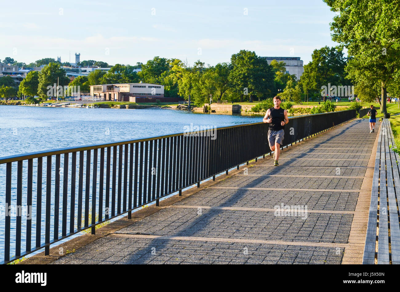 Washington DC, Stati Uniti d'America - Agosto 15, 2013: uomo jogging dal fiume Potomac con skyline di Georgetown sul marciapiede Foto Stock