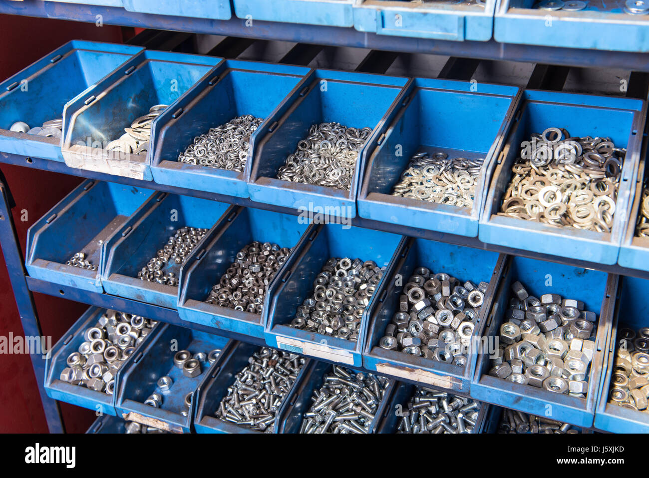 Storage a vite in blu le casse di plastica in un workshop Foto Stock