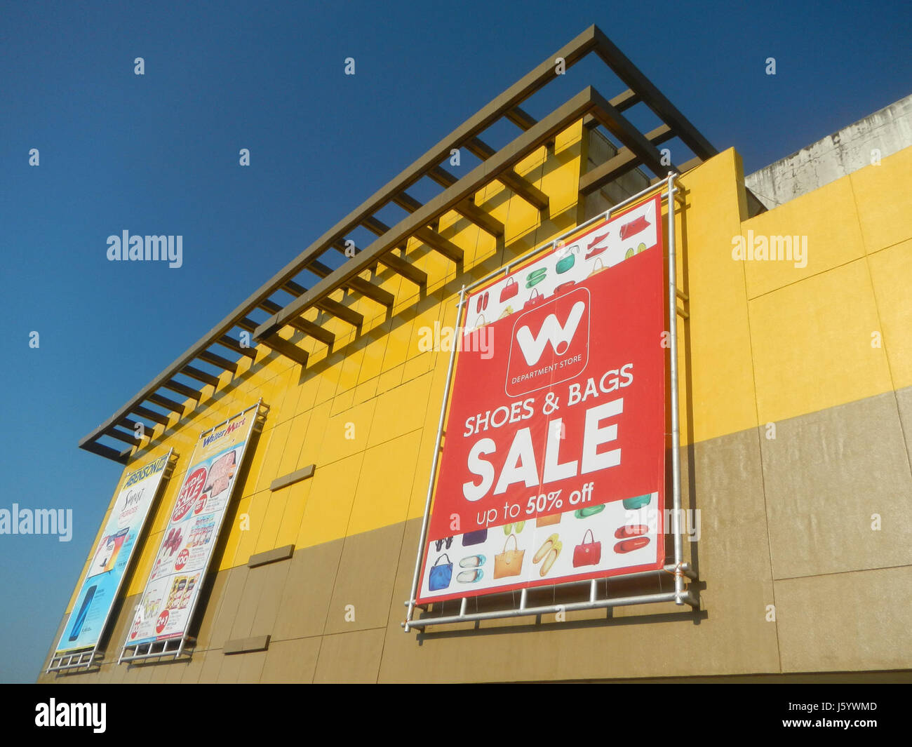Questa immagine mostra l'esterno del Water Mart a Plaridel, Bulacan, Filippine. Mette in risalto l'ambiente commerciale della zona, fungendo da spazio commerciale per la gente del posto e contribuendo all'economia locale. Foto Stock