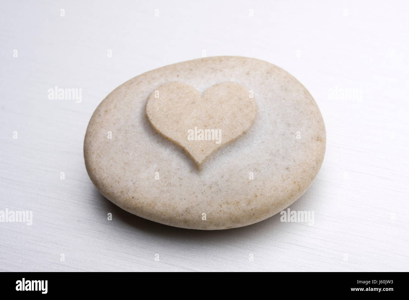 Cuore di pietra grigio grigio pietra astratta di forma ovale di rotocalcografia sagomatura di design Foto Stock