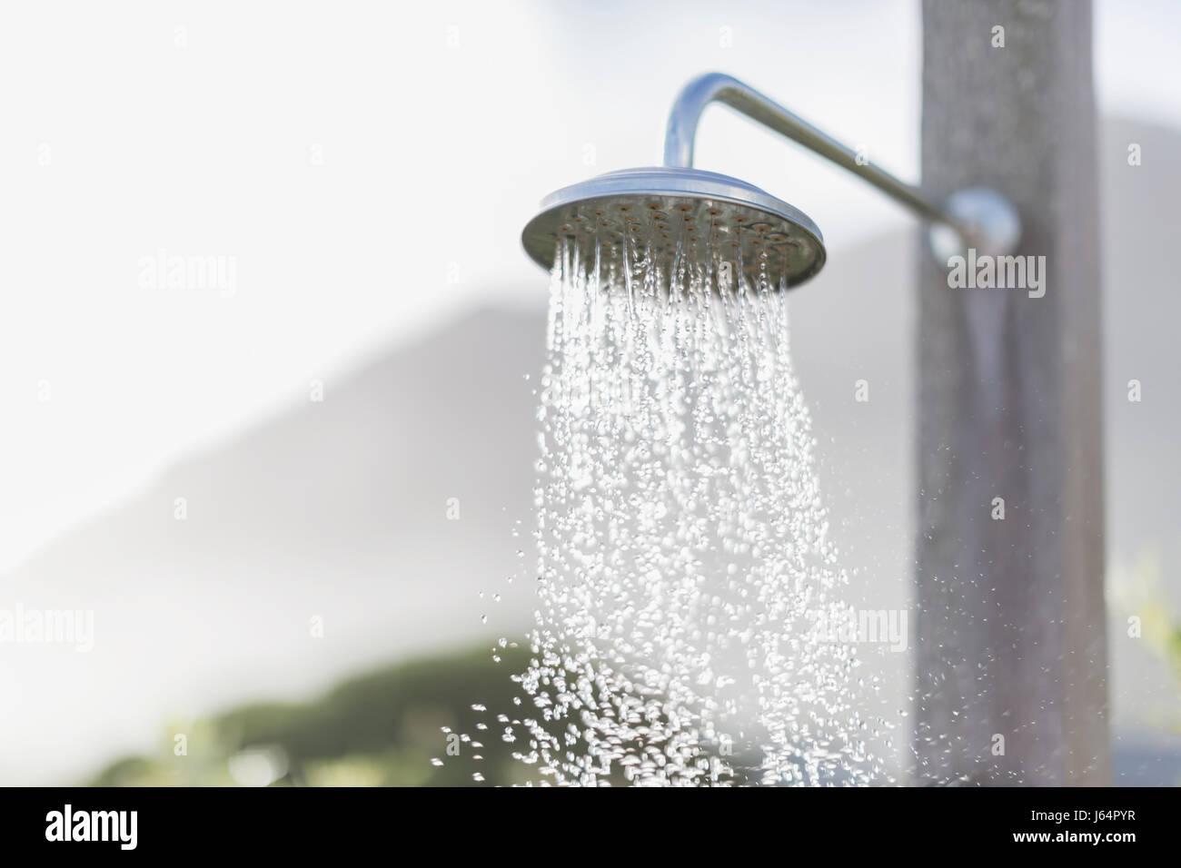 L'acqua che cade dalla doccia esterna testa Foto Stock