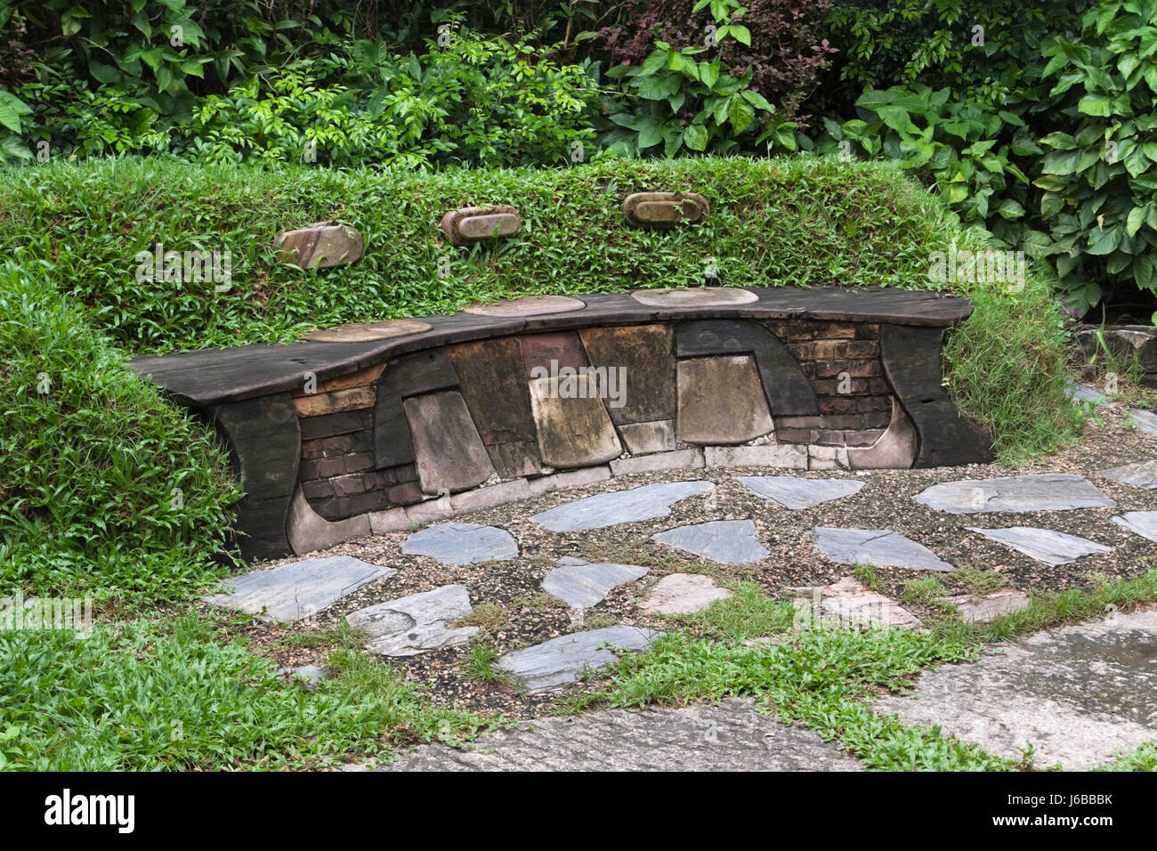 Il parco giardino boccole sedile banco giardini natura foglia ambiente ambiente Foto Stock