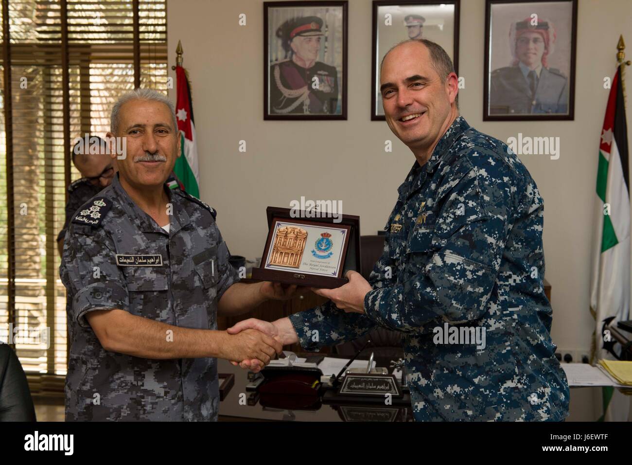 170507-N-KD168-017 Aqaba Giordania (7 maggio 2017) Capt. Eric Phister, comandante, Amphibious Assault nave USS Bataan (LHD 5), riceve un regalo da brigadiere generale Ibrahim Alnaimat ad una riunione precedente esercizio desiderosi Lion 2017. L'esercizio annuale con il Regno hascemita di Giordania è progettato per lo scambio di consulenze militari e di migliorare l'interoperabilità tra nazioni partner. La nave e il suo gruppo pronto sono distribuiti negli Stati Uniti Quinta Flotta area di operazioni a sostegno della sicurezza marittima operazioni destinate a rassicurare gli alleati e partner e preservare la libertà di navigazione e Foto Stock