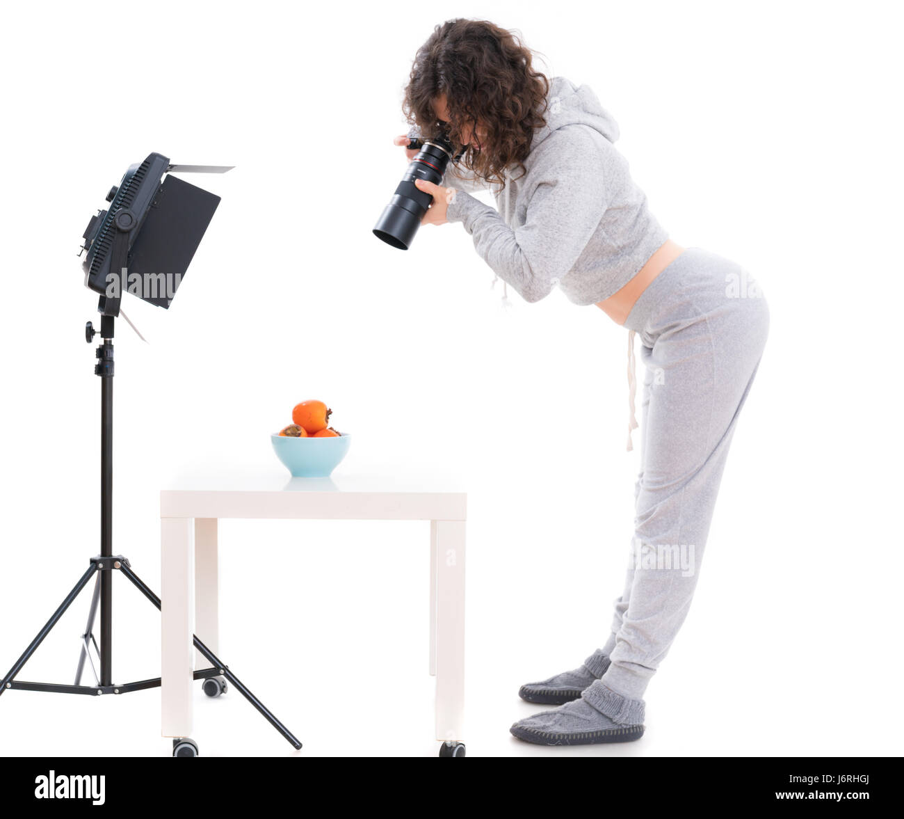 Ragazza fotografo isolato su bianco Foto Stock