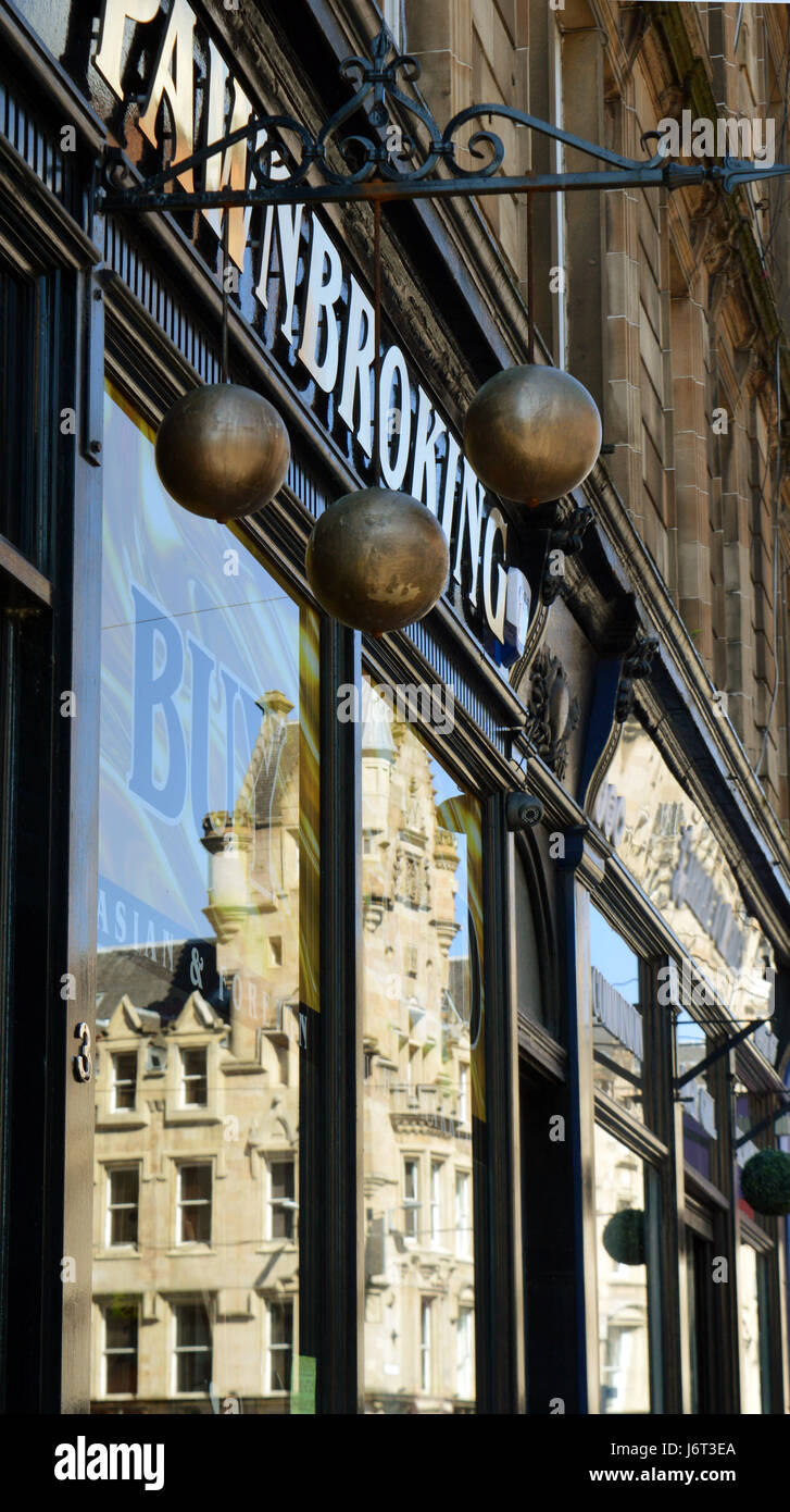 Am opulento palazzo riflette in pawnbroker della finestra sotto le tre sfere di oro, il tradizionale segno dell'pawnbroker. Foto Stock