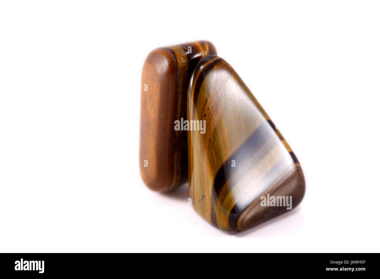 Rocce di pietra levigata gioiello prezioso minerale blu vicino a calice di vetro tumbler macro Foto Stock