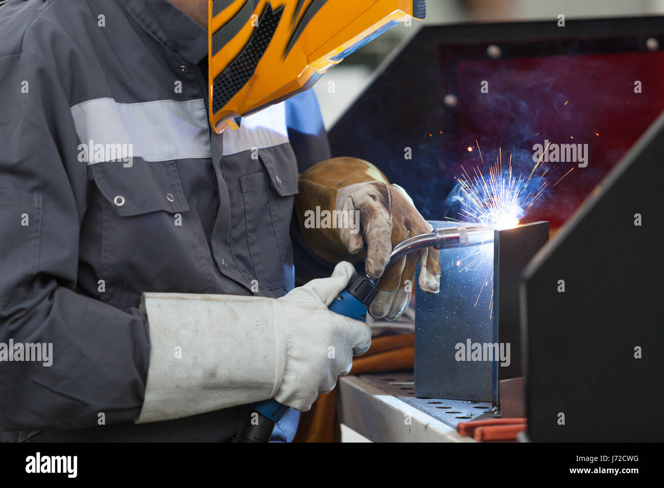 Lavoratore con maschera protettiva in metallo di saldatura Foto Stock