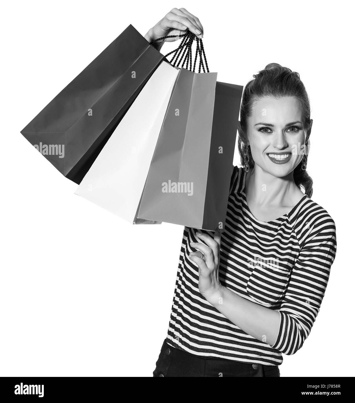 Shopping. Il modo francese. Ritratto di donna moderna con le borse della spesa dei colori della bandiera francese isolato su bianco Foto Stock