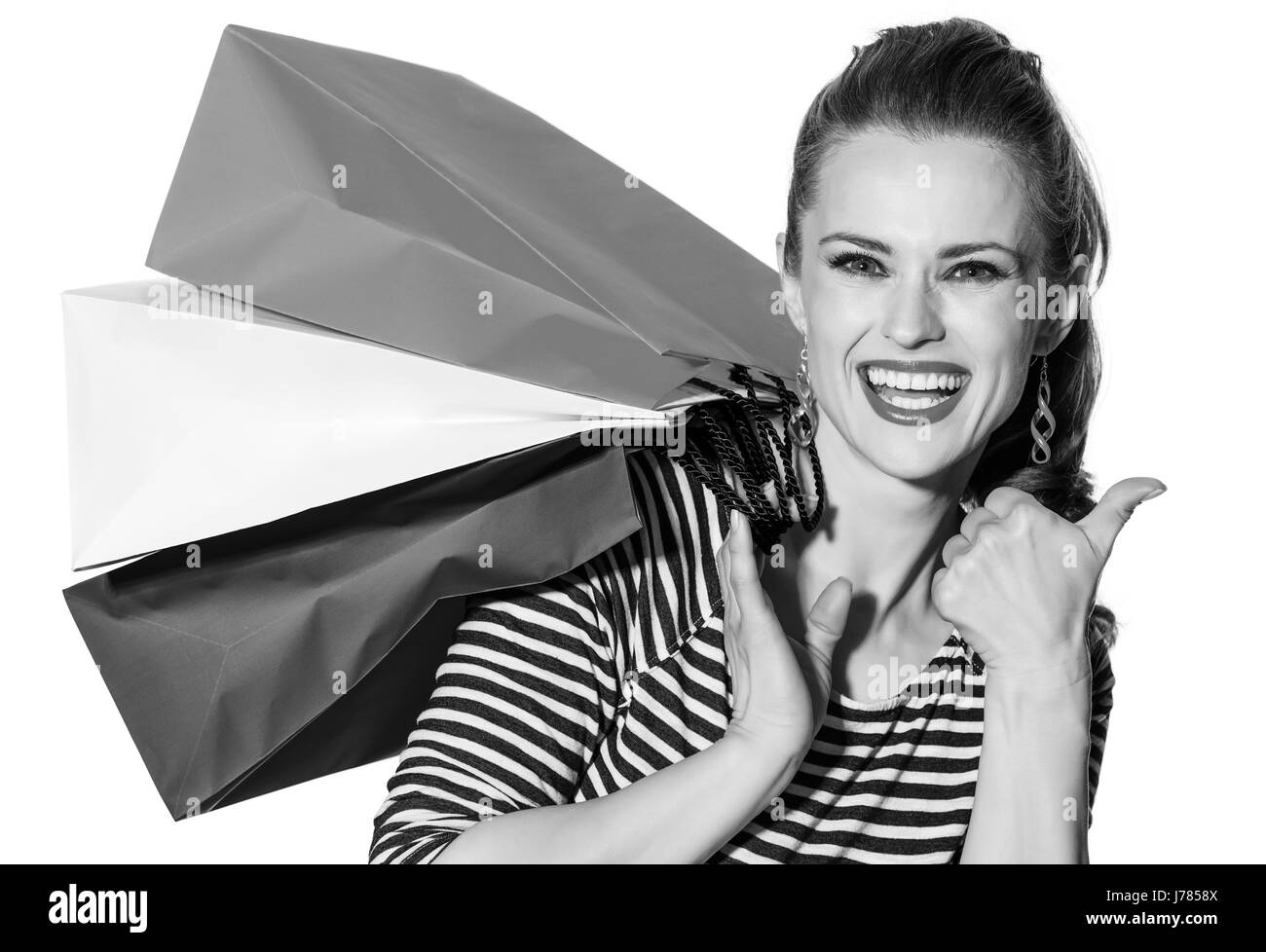 Shopping. Il modo francese. Ritratto di sorridere alla moda-monger con borse della spesa dei colori della bandiera francese isolati su sfondo bianco Foto Stock