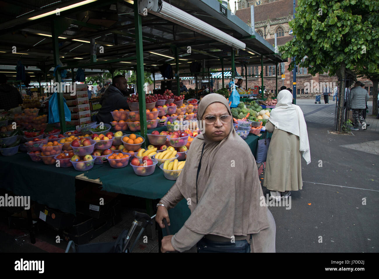 Multiculturale di scena a Bullring mercato aperto, all'aperto del mercato alimentare nella zona centrale di Birmingham, Regno Unito. Il mercato aperto offre una grande varietà di frutta e verdura fresca, tessuti, oggetti per la casa e prodotti stagionali. Il Bull Ring mercato aperto ha 130 bancarelle. Foto Stock